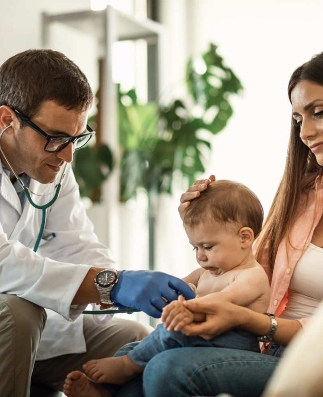 baby-boy-getting-medical-exam-by-doctor-while-being-with-mother-pediatrician-s-scaled (1)